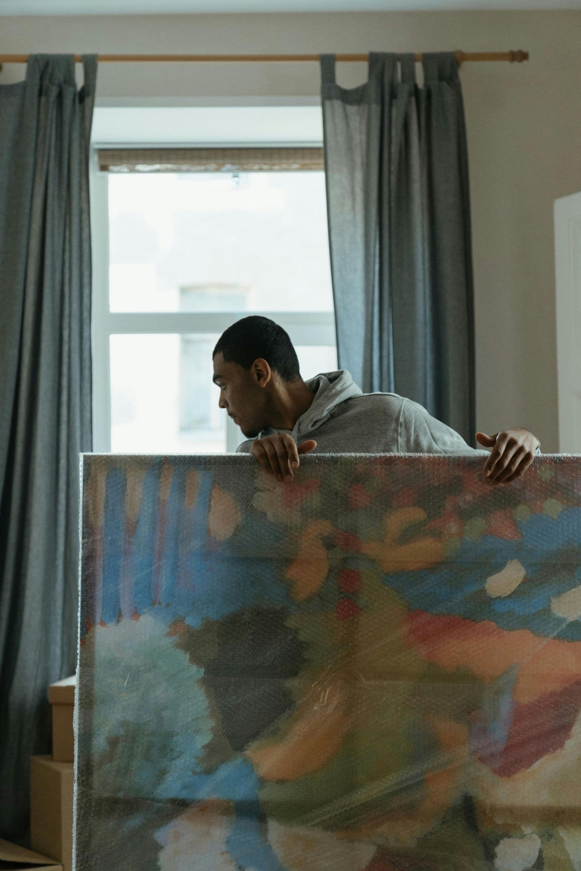 Man carefully handling fine art painting