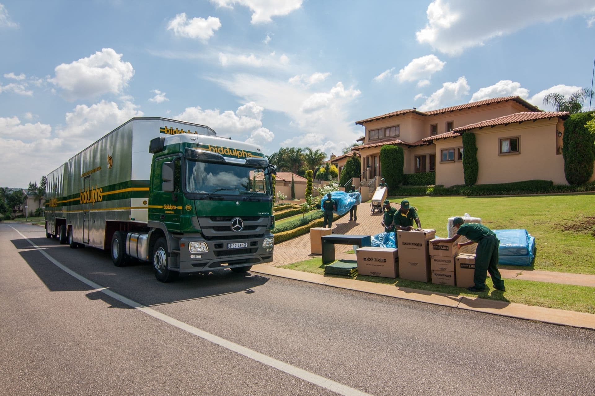 Biddulphs moving truck and professional movers loading furniture at a residential property