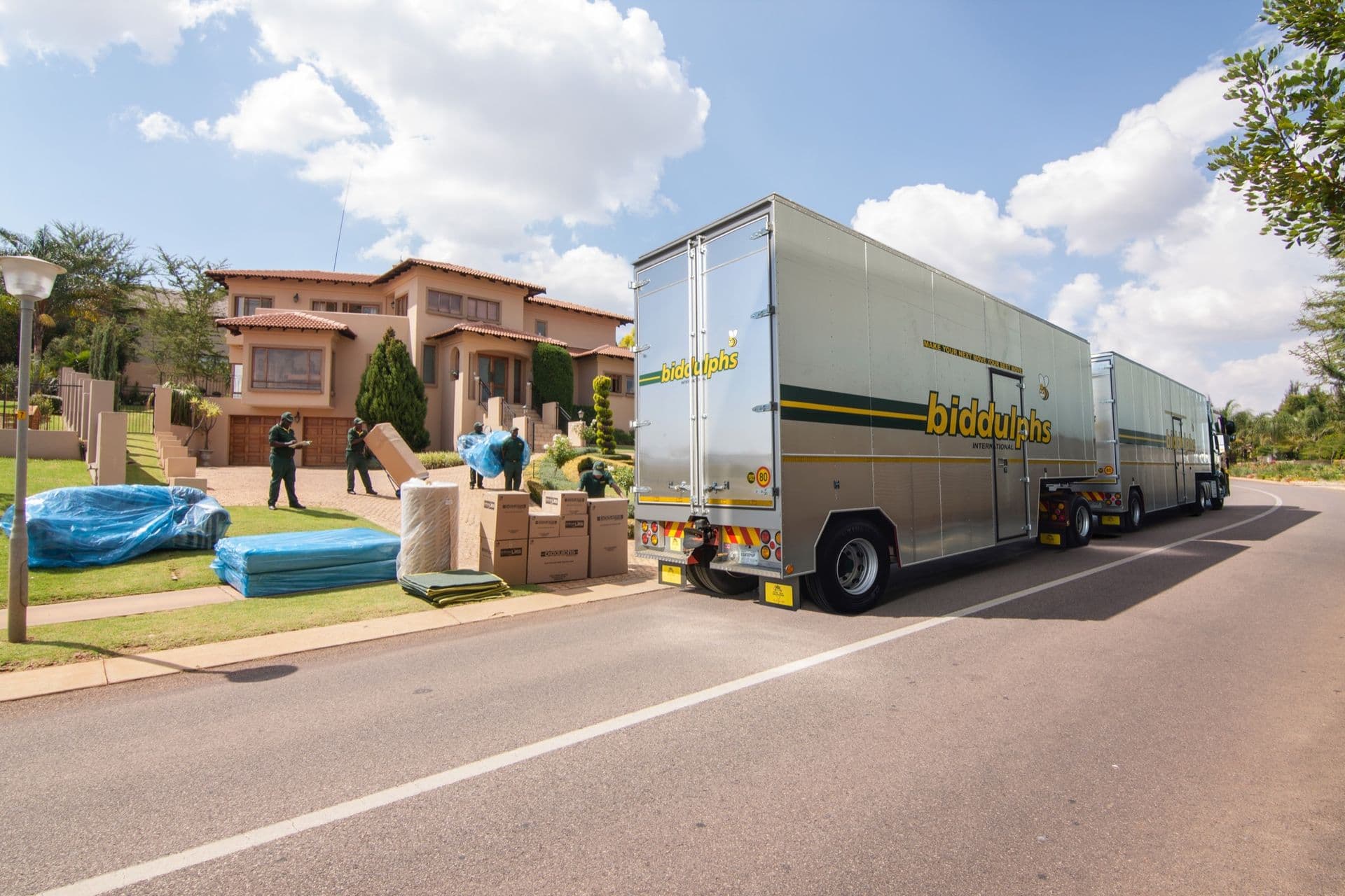 Biddulphs moving trucks and professional movers loading furniture