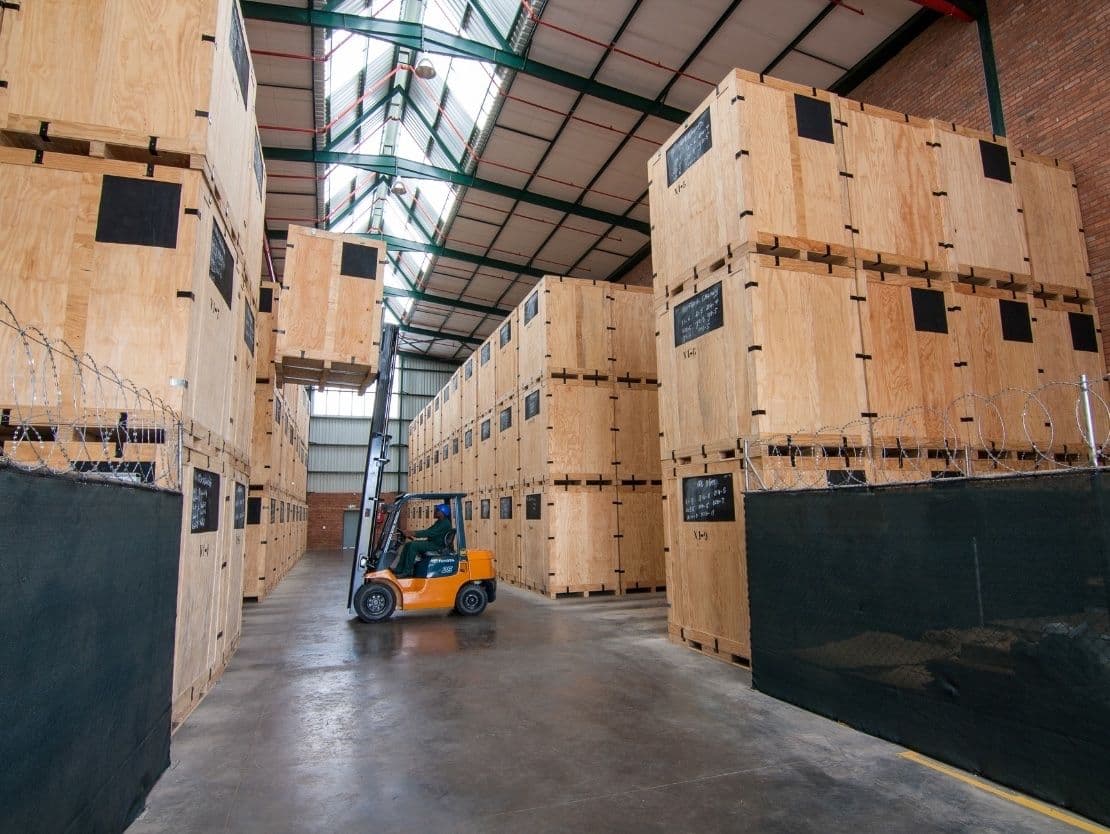 Modern palletised storage warehouse with forklift