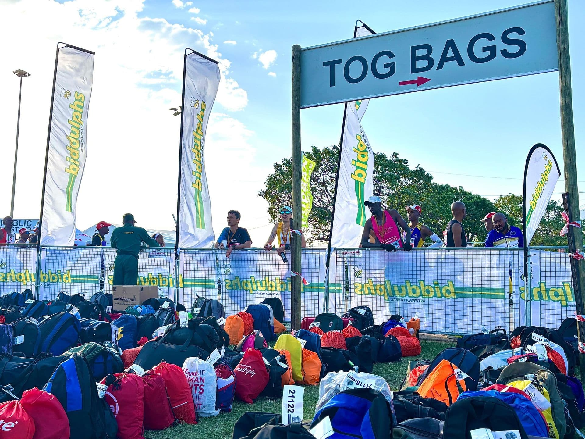 Yellow Tog Bags directional sign with Biddulphs flags and runners collecting their bags