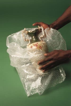 Fine art vase being wrapped in protective bubble wrap