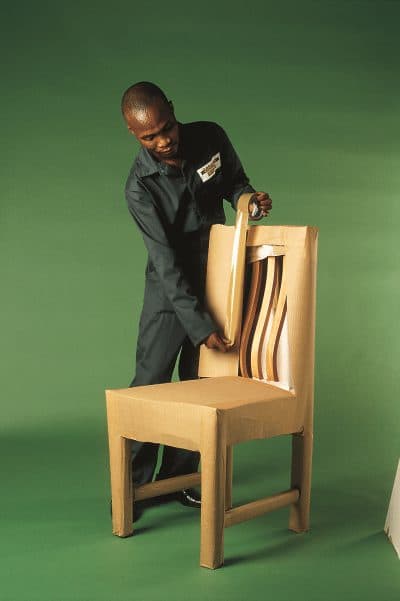 Professional packer assessing and wrapping a dining chair